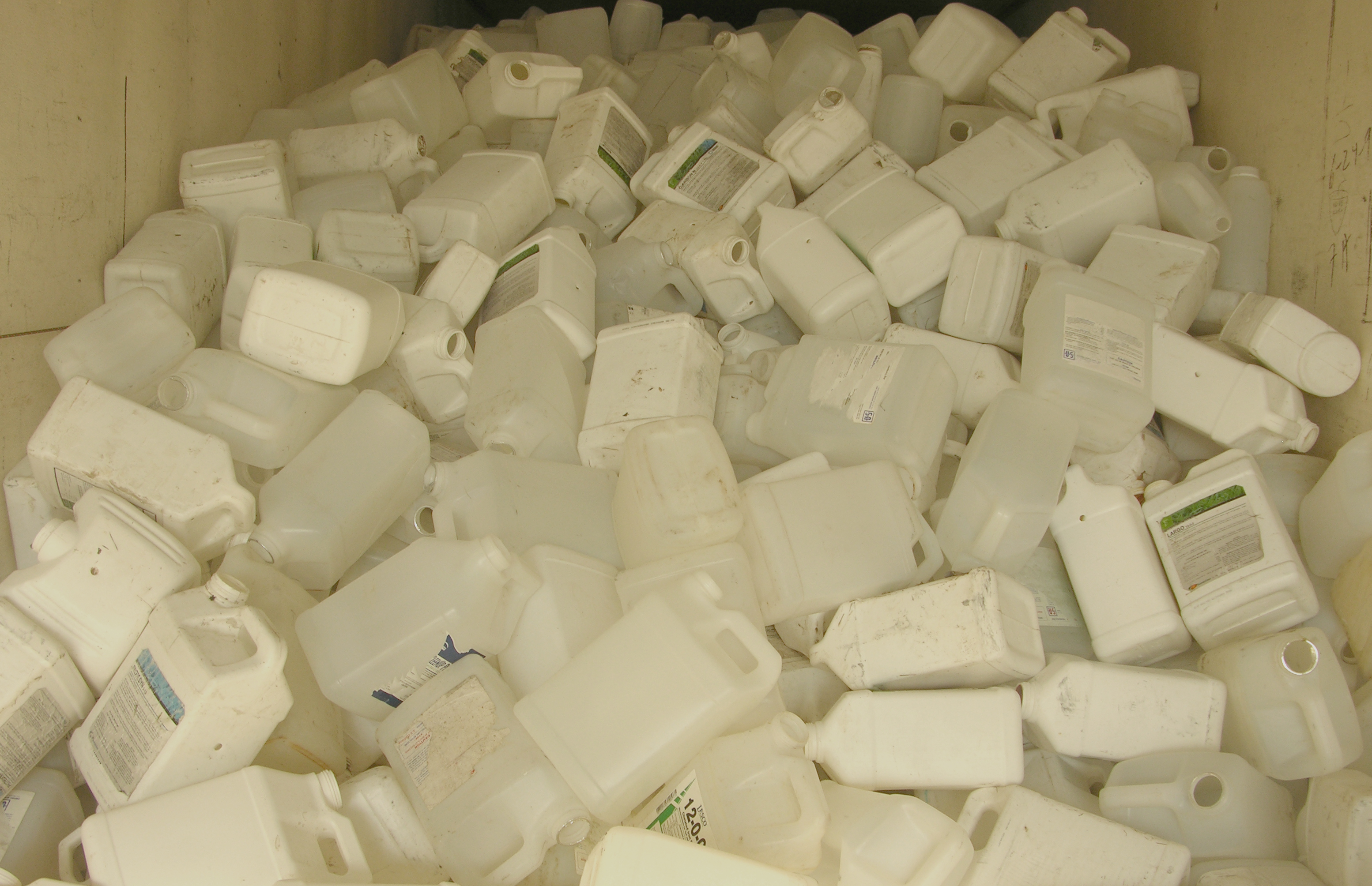 A pile of properly rinsed pesticide containers collected for recycling